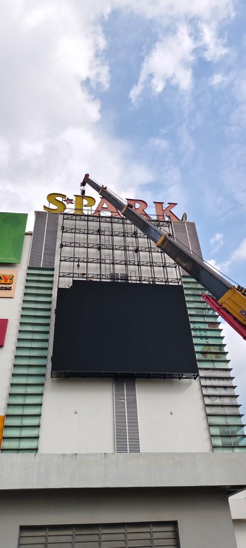 Large outdoor LED billboard being installed on a commercial building